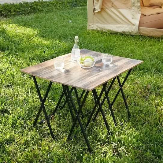 5-piece folding TV tray table set with wood grain tops and black metal legs on grass outdoors