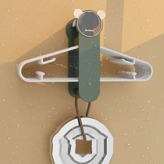 Wall-mounted clothes hanger storage rack holding multiple white hangers with a round green base