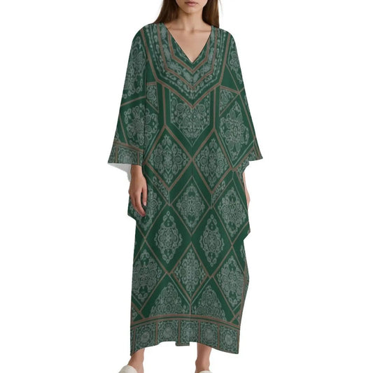 Woman wearing green V-neck kaftan dress with intricate diamond and floral pattern