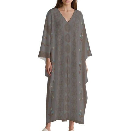 Woman wearing grey V-neck kaftan dress with floral and geometric patterns