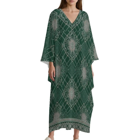 Woman wearing green V-neck kaftan dress with geometric and sunburst patterns on white background