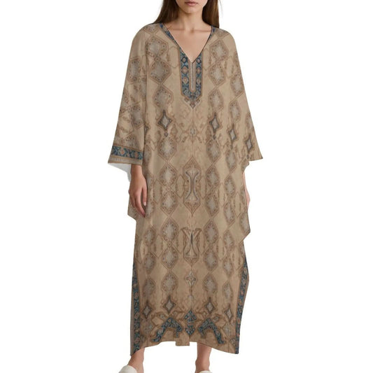 Woman wearing beige patterned V-neck kaftan dress with geometric motifs and blue accents