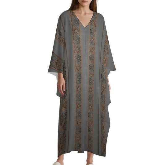 Woman wearing a loose grey and brown patterned V-neck kaftan dress with wide sleeves