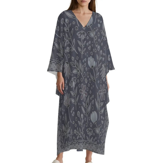 Woman wearing a dark gray V-neck kaftan dress with white floral print and wide sleeves