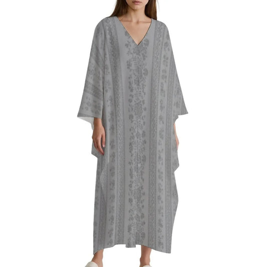 Woman wearing gray V-neck kaftan dress with floral vertical stripes and wide sleeves