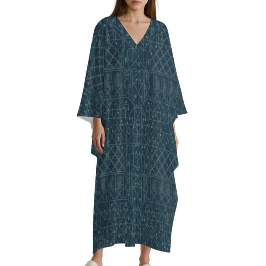 Woman wearing a loose fit blue V-neck kaftan dress with geometric and paisley patterns