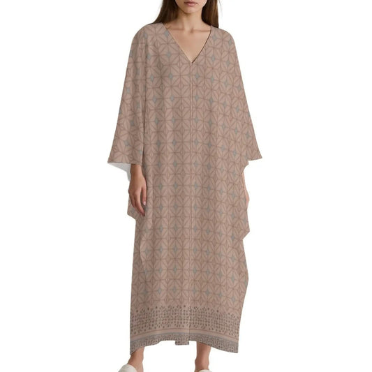 Woman wearing a beige V-neck kaftan dress with geometric pattern and wide sleeves