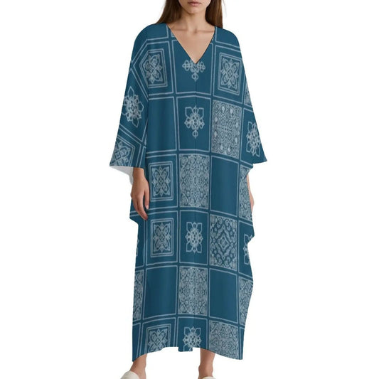 Woman wearing blue V-neck kaftan dress with white geometric tile patterns