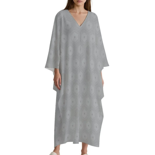 Woman wearing light gray V-neck kaftan dress with subtle geometric pattern and loose long sleeves