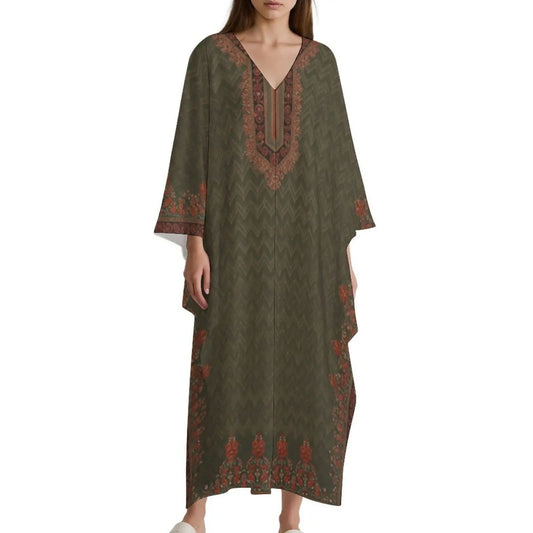 Woman wearing olive green v-neck kaftan dress with orange floral and chevron patterns