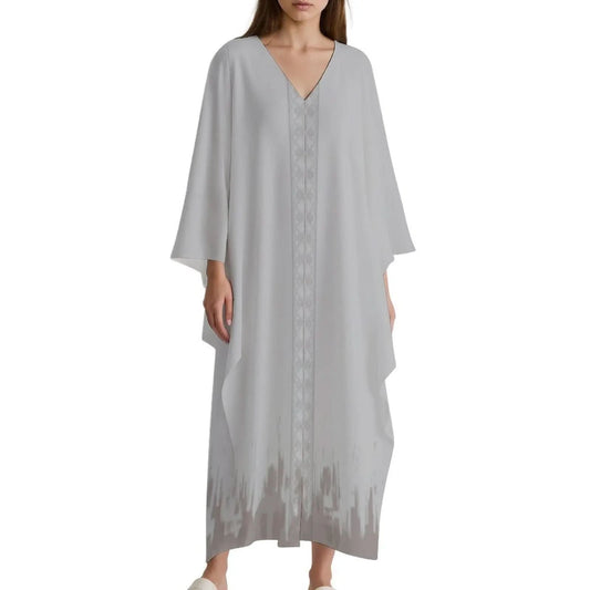Woman wearing light gray V-neck kaftan dress with subtle central pattern and darker gradient hem