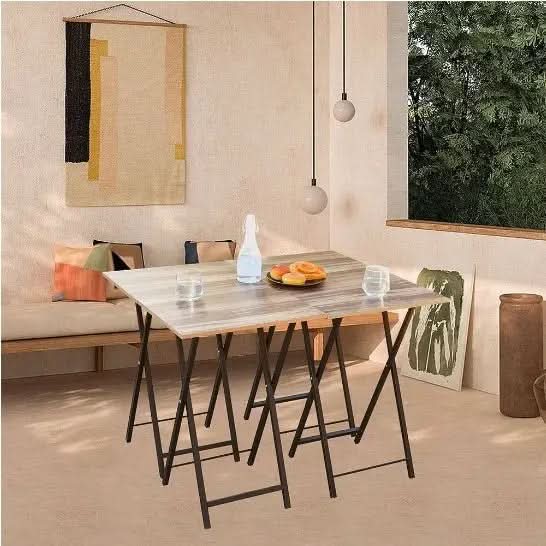5-piece folding TV tray table set with faux wood tops and black metal legs in a cozy, minimalist room