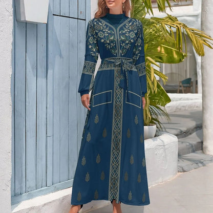 woman wearing blue long sleeve high neck embroidered long dress with belt standing outdoors