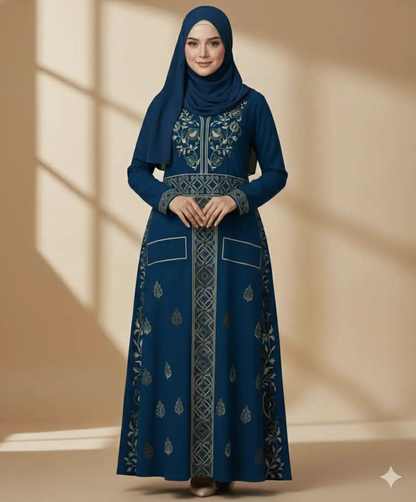 Woman wearing a blue embroidered long sleeve high neck dress with matching hijab against neutral backdrop
