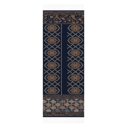 Navy blue scarf with tan floral and geometric patterns and white tassels on edges