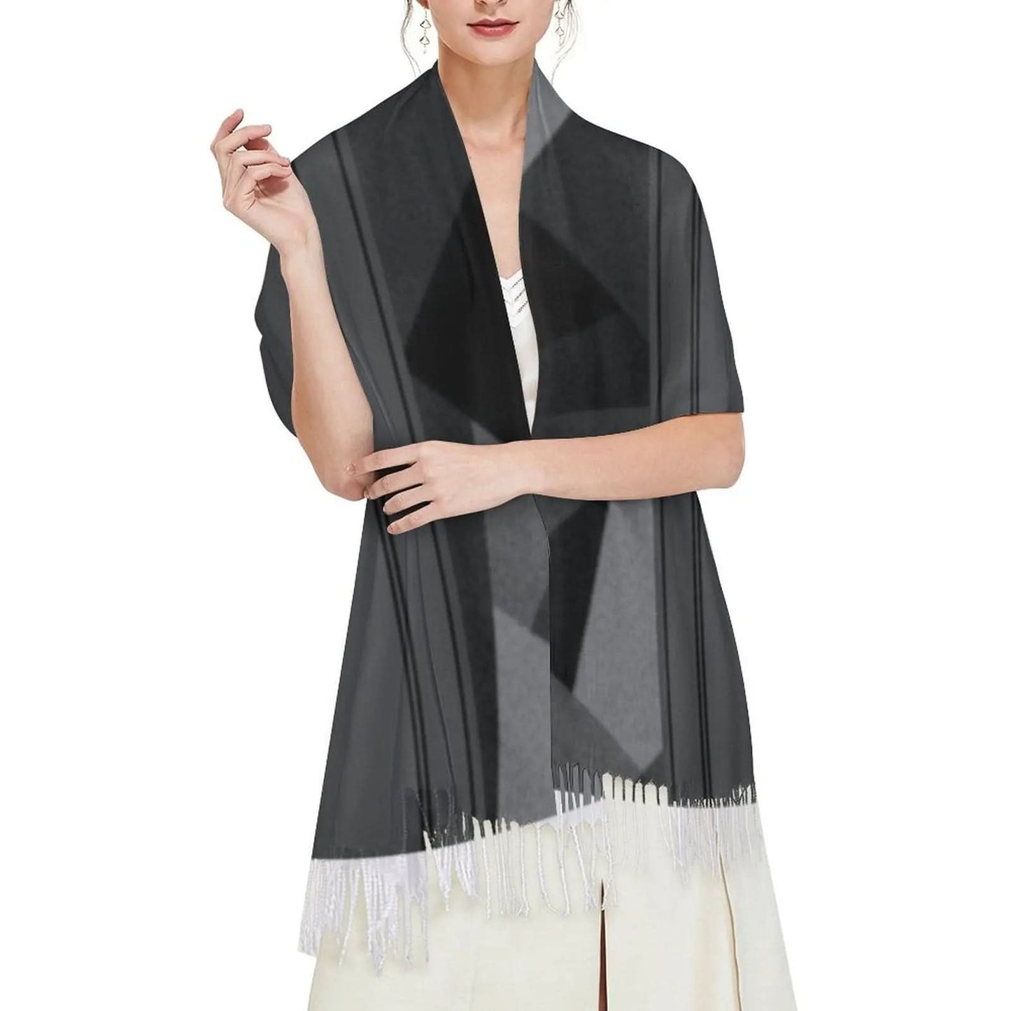 Woman wearing black geometric tassel scarf over white dress on white background