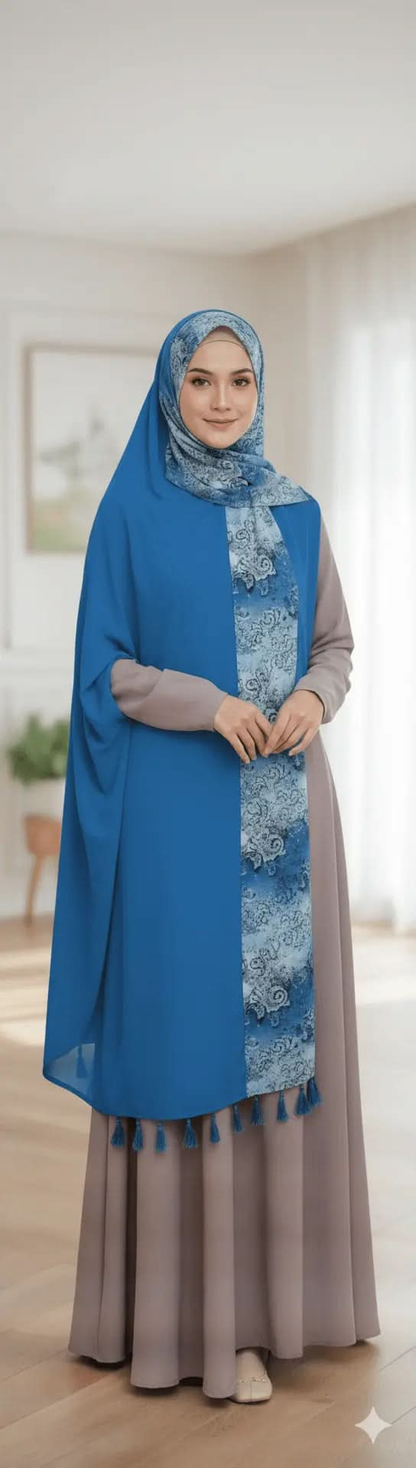 Woman wearing blue patterned tassel scarf and taupe modest dress in bright room
