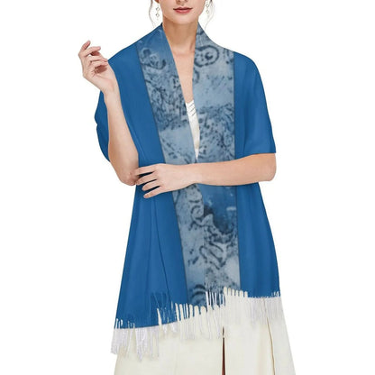 Woman wearing elegant blue tassel scarf with patterned inner design over white dress