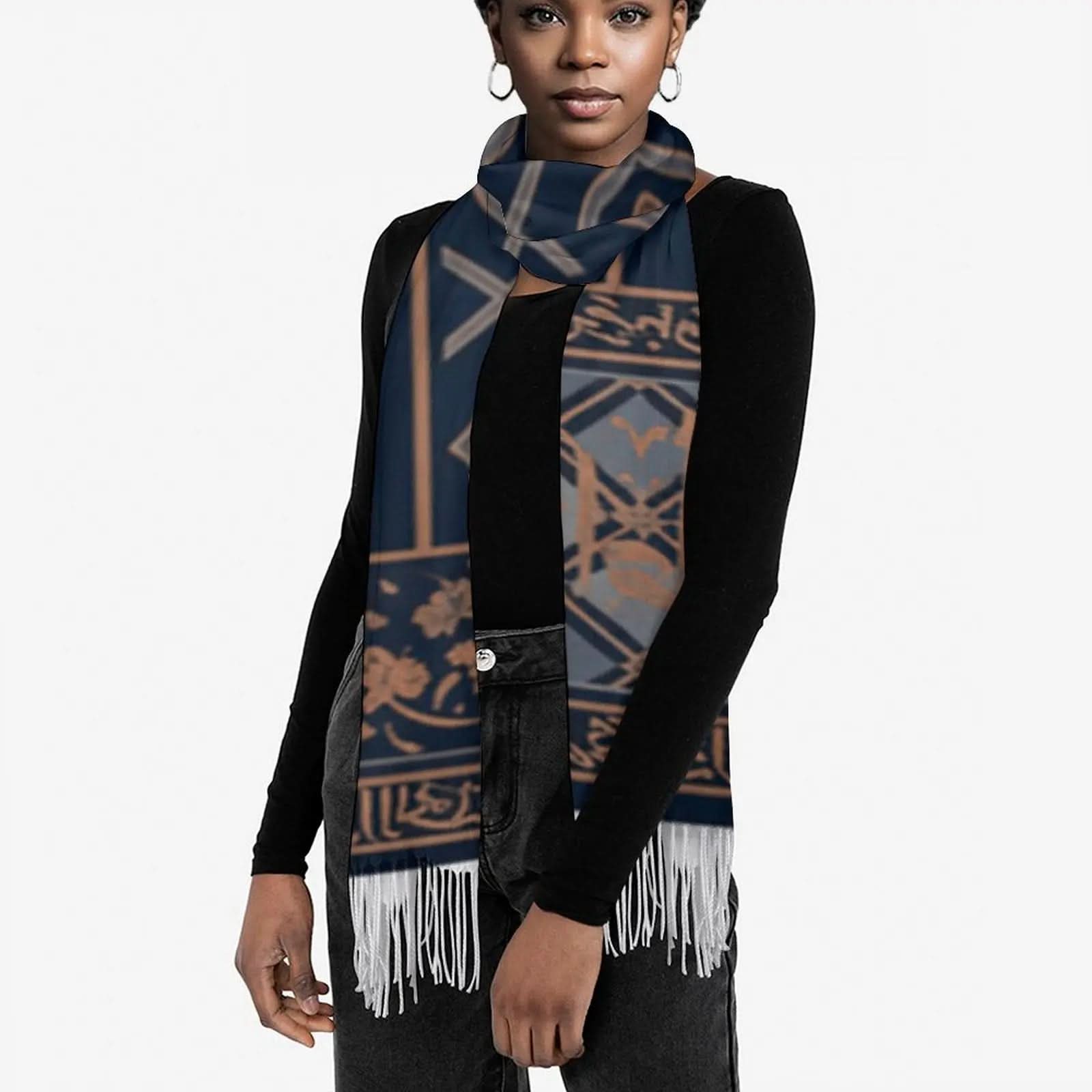 Woman wearing navy blue and tan patterned tassel scarf with black long sleeve top and jeans