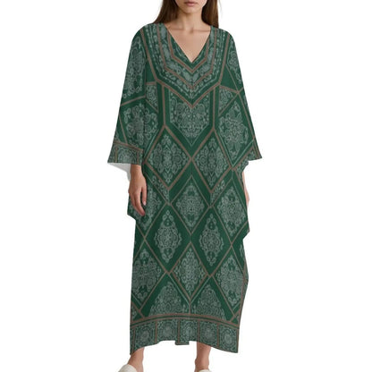 Woman wearing green V-neck kaftan dress with intricate diamond and floral pattern
