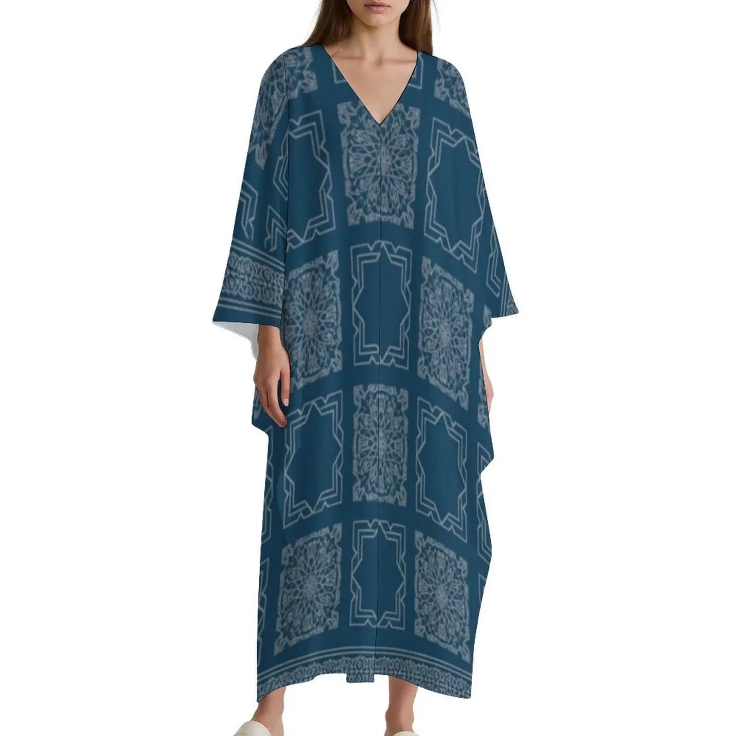 Woman wearing blue V-neck kaftan dress with light geometric and floral patterns