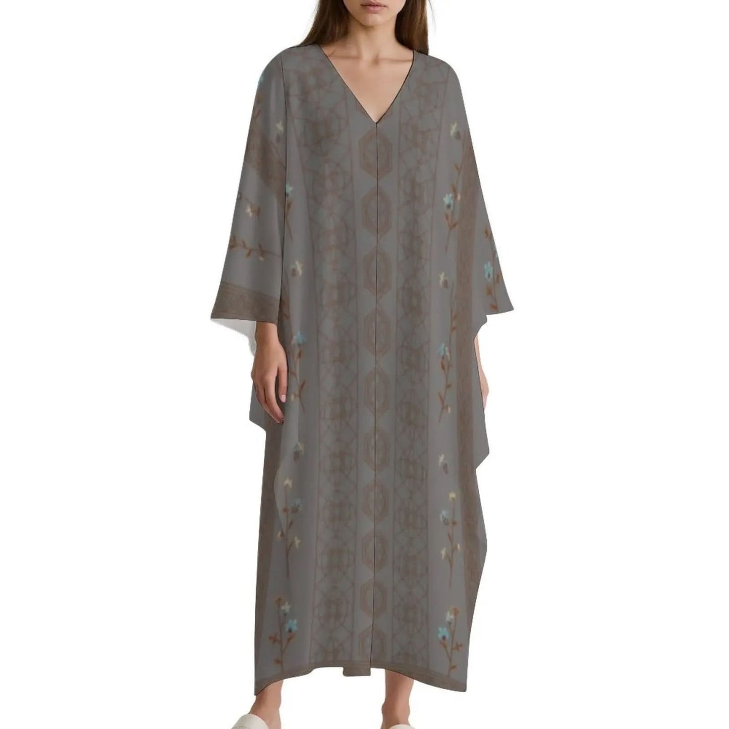 Woman wearing grey V-neck kaftan dress with floral and geometric patterns