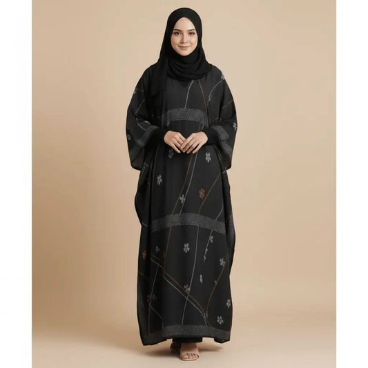 Woman wearing black kaftan dress with floral patterns and black hijab on beige background