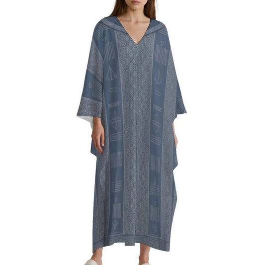 Woman wearing a blue patterned V-neck kaftan dress with wide sleeves on a white background