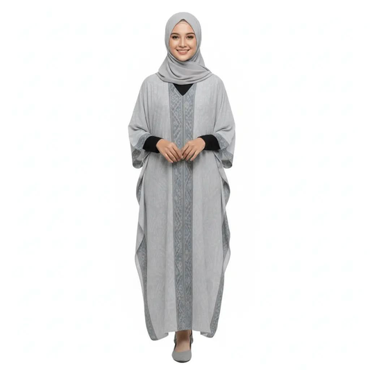 Smiling woman wearing gray v-neck kaftan dress with patterned vertical stripe and matching hijab