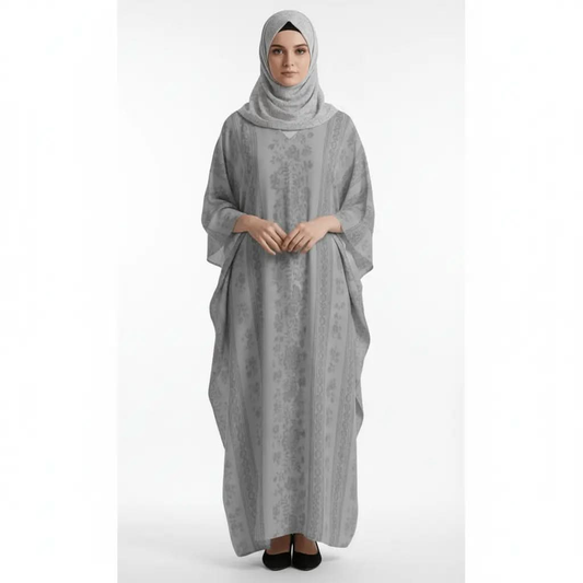 Woman wearing a grey patterned V-neck kaftan dress and grey hijab with black shoes on white background
