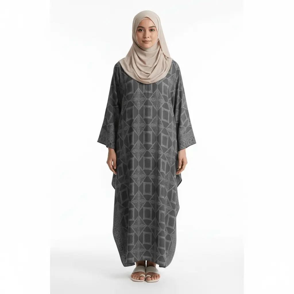 Woman wearing dark grey geometric patterned kaftan dress with beige hijab and white sandals