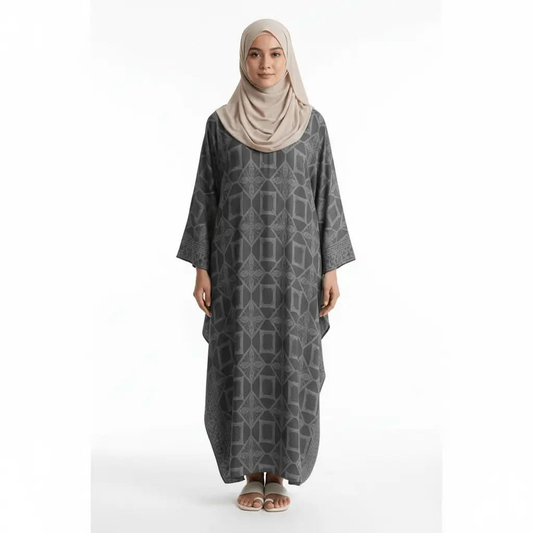 Woman wearing dark grey geometric patterned kaftan dress with beige hijab and white sandals