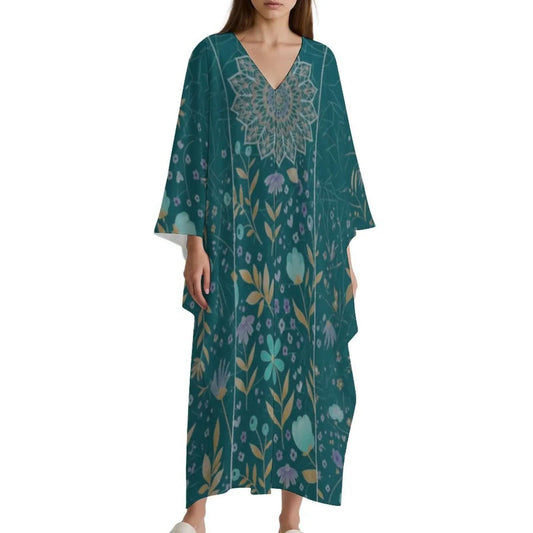 Woman wearing teal floral v-neck kaftan dress with loose sleeves on white background