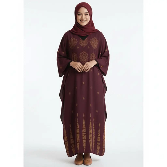 Smiling woman wearing maroon V-neck kaftan dress with gold patterns and matching hijab