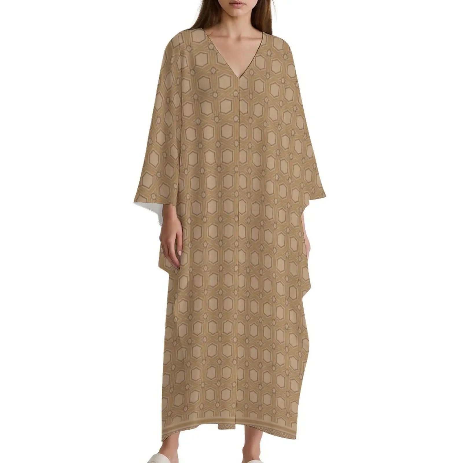 Model wearing beige v-neck kaftan dress with geometric hexagon pattern and wide sleeves