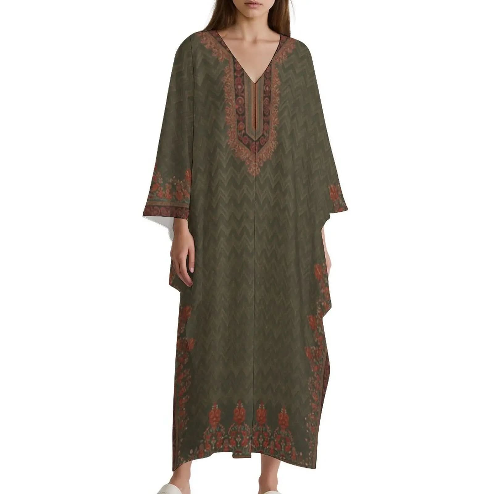 Woman wearing olive green v-neck kaftan dress with orange floral and chevron patterns
