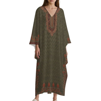 Woman wearing olive green v-neck kaftan dress with orange floral and chevron patterns