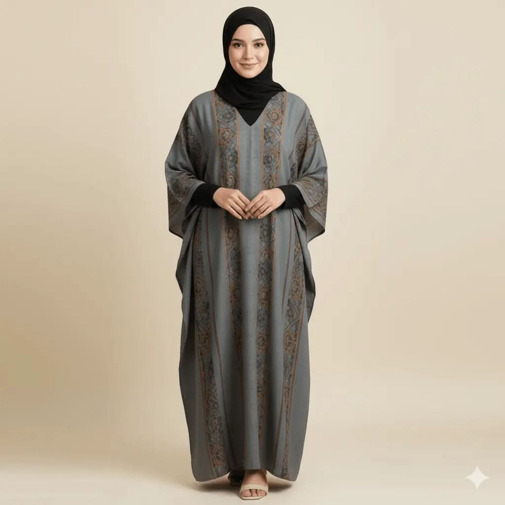 Woman wearing a grey and brown patterned V-neck kaftan dress with black hijab and beige sandals