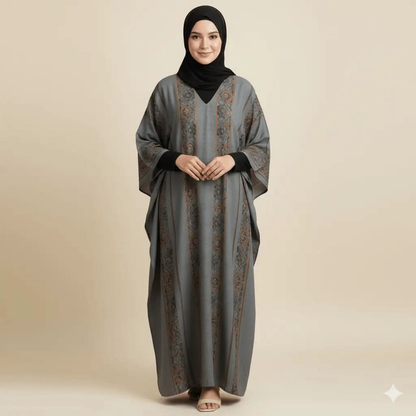 Woman wearing a grey and brown patterned V-neck kaftan dress with black hijab and beige sandals