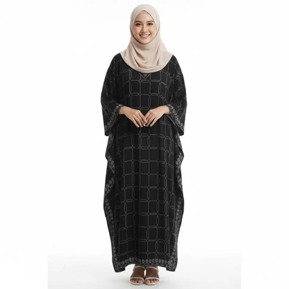 Smiling woman in beige hijab wearing black V-neck kaftan dress with geometric patterns, standing 
