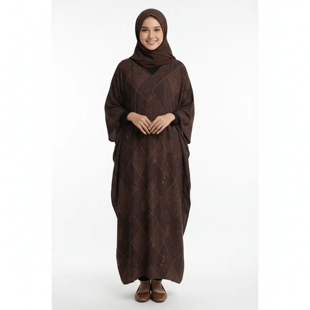 Woman wearing brown patterned V-neck kaftan dress with matching hijab and brown shoes on white background