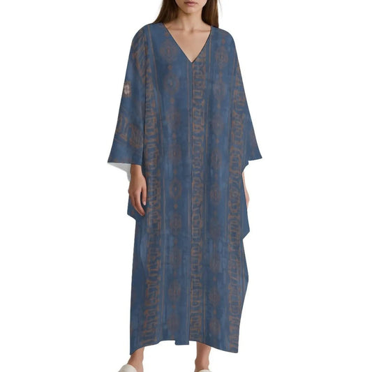 Woman wearing a blue V-neck kaftan dress with brown geometric patterns on a white background