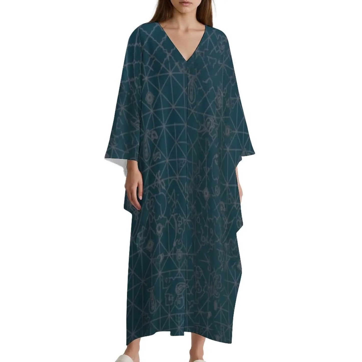 Woman wearing a teal V-neck kaftan dress with light geometric and abstract patterns
