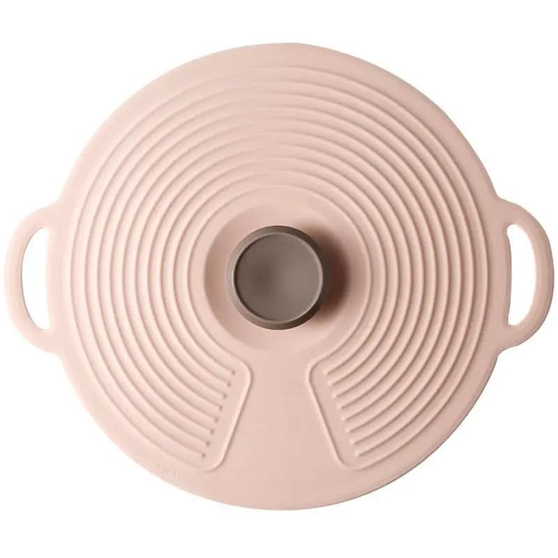 Round pink food-grade silicone lid with handles and concentric circular ridges for sealing